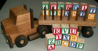 The truck is designed to hold two sets of colorful wooden alphabet
